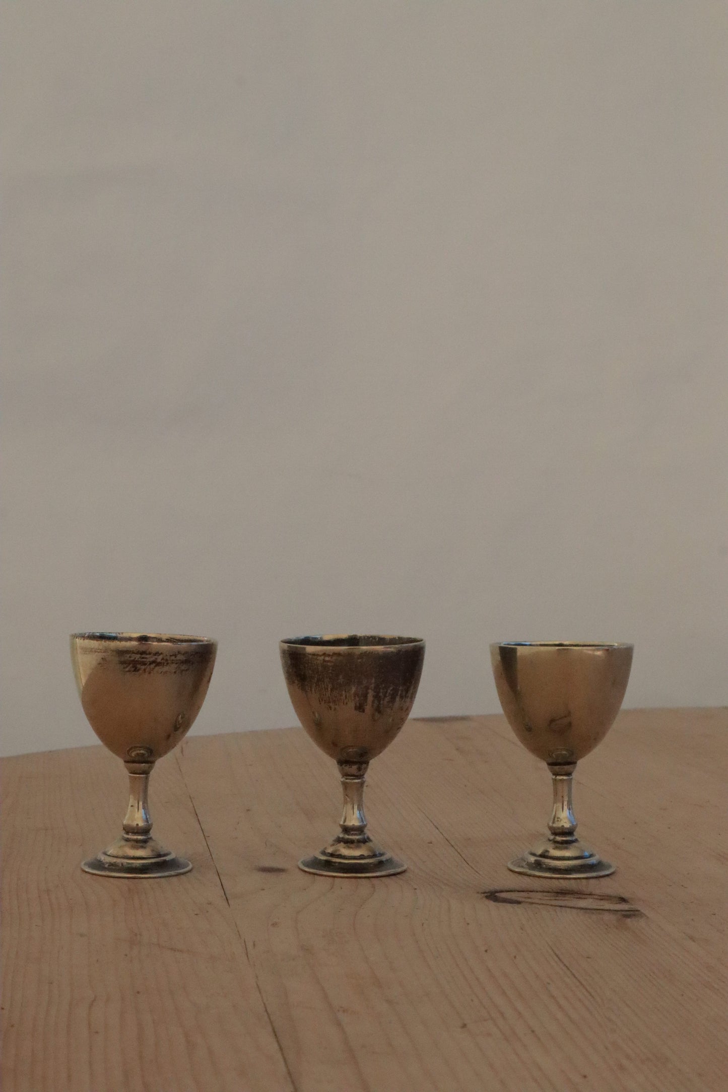 Three silvered egg cups