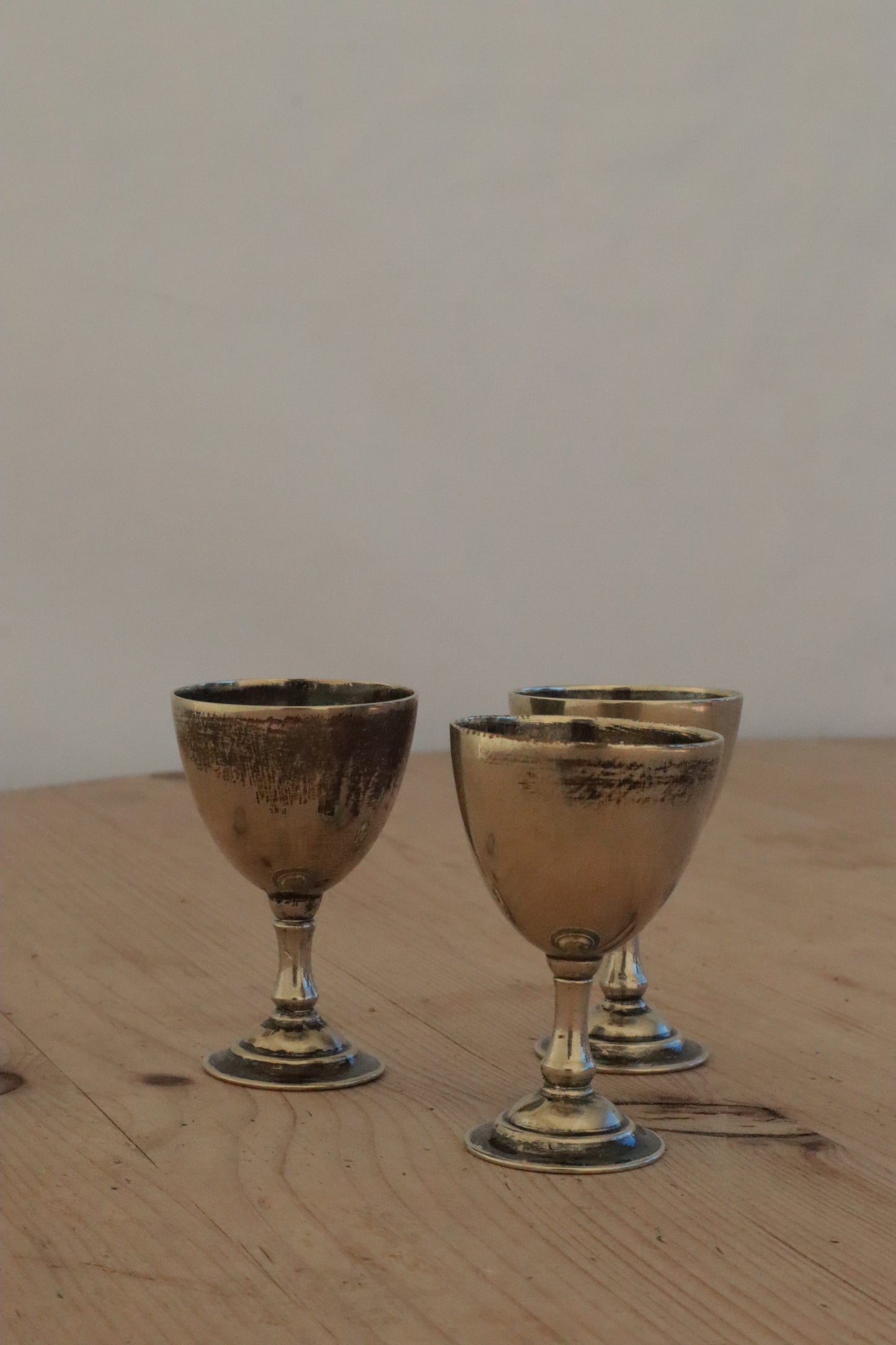 Three silvered egg cups