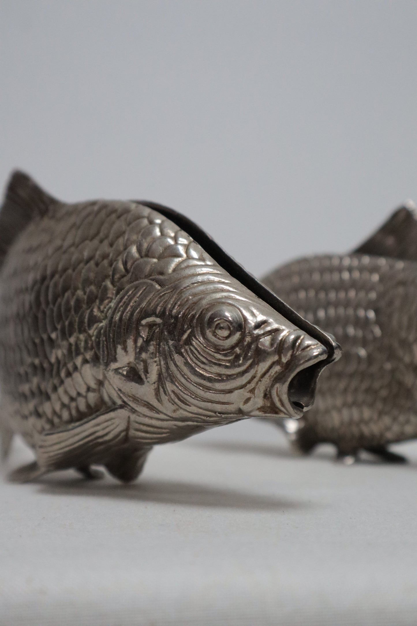 Silvered fish menu holder