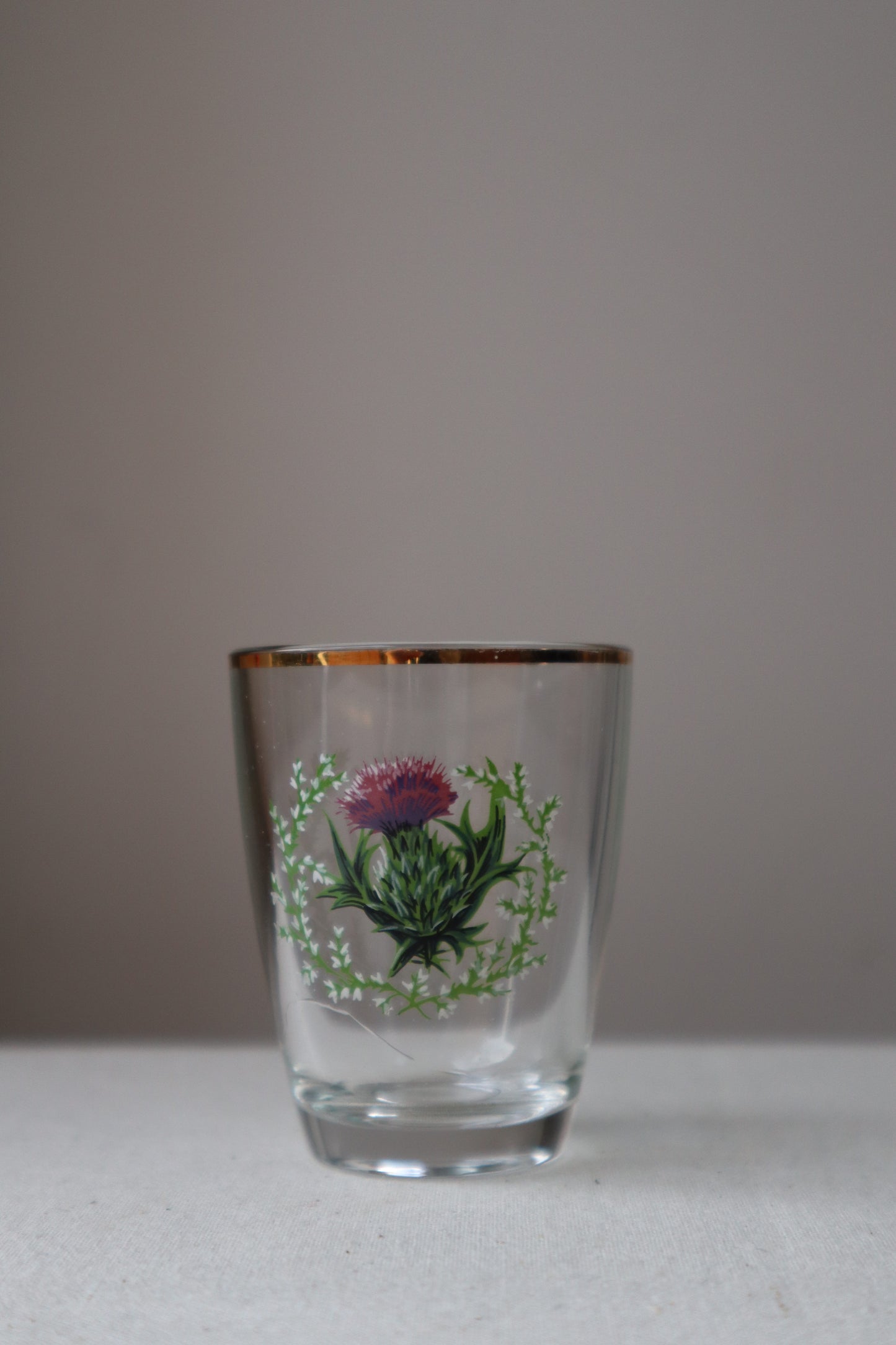 Shot glass with painted thistle