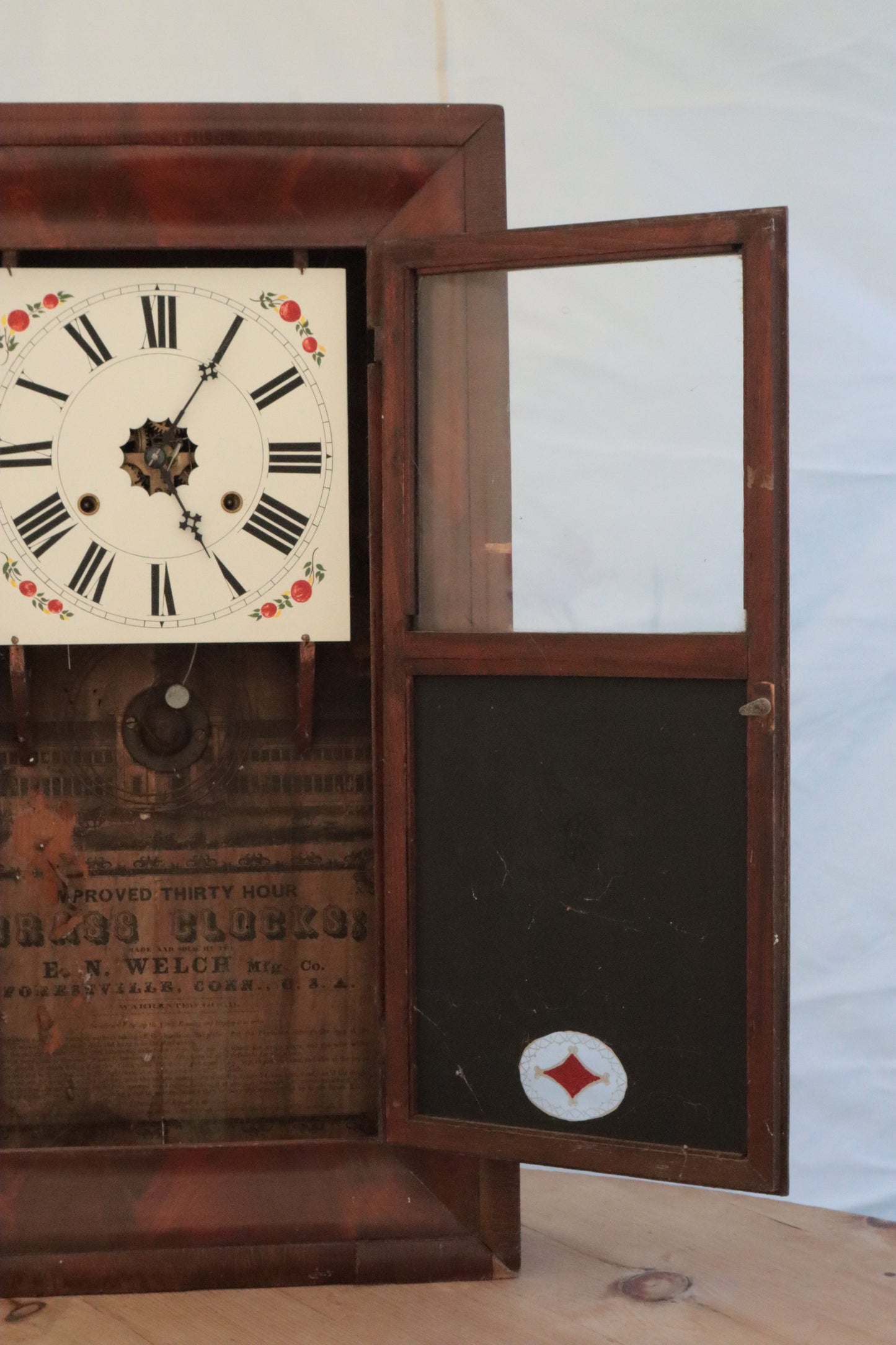 Wall clock with painted panel