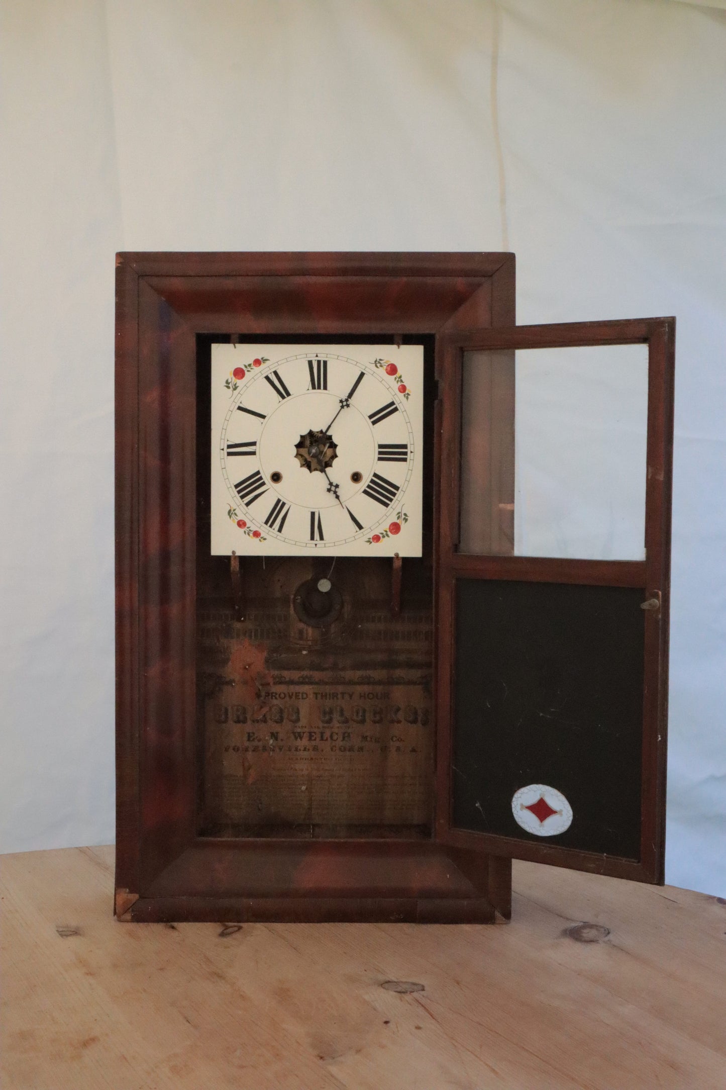 Wall clock with painted panel