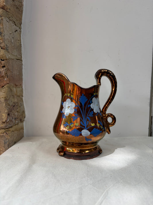 A vintage lustre jug with a floral design in blue, white. 